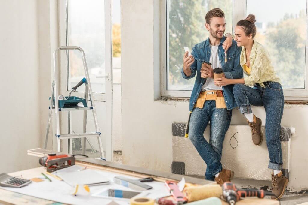 happy couple in a rental home, among home improvements