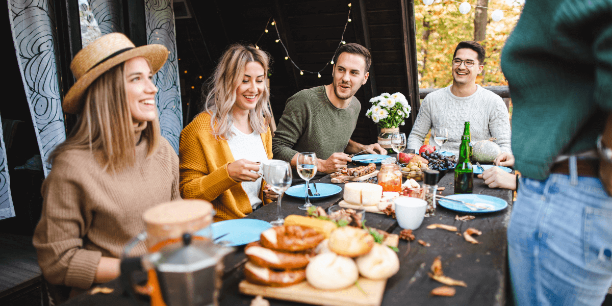 People sitting around a table enjoying food | Fire Safety Tips