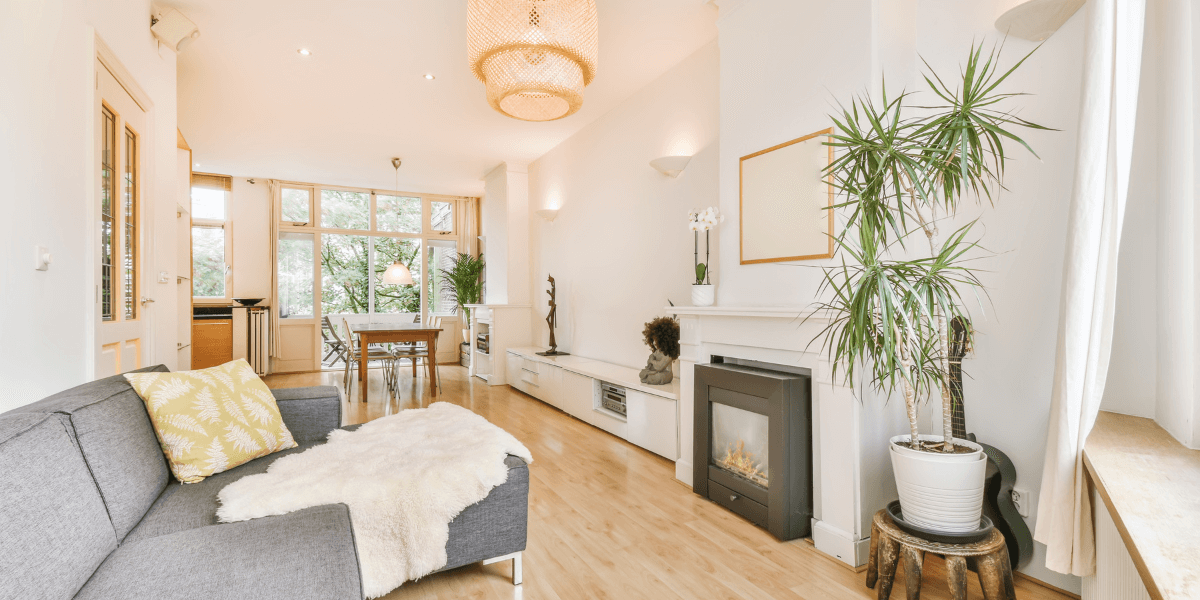 Bright living room with grey couch and white walls | Showing a Property
